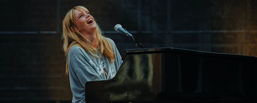 Blonde woman on a black piano